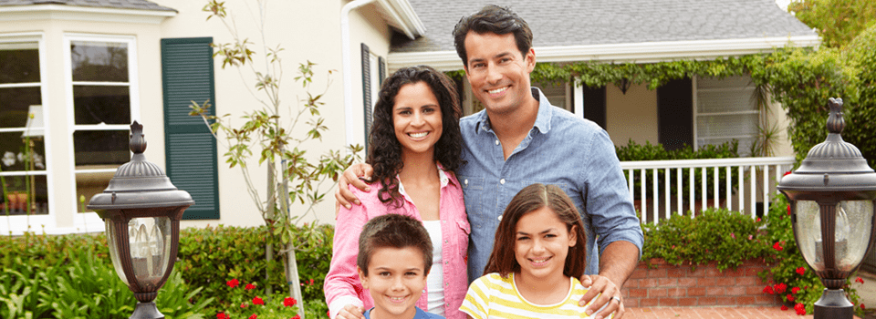 Family in front of their new house